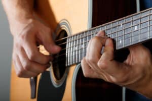 CAGED Guitar | See it in action | photo of man playing guitar with CAGED guitar model